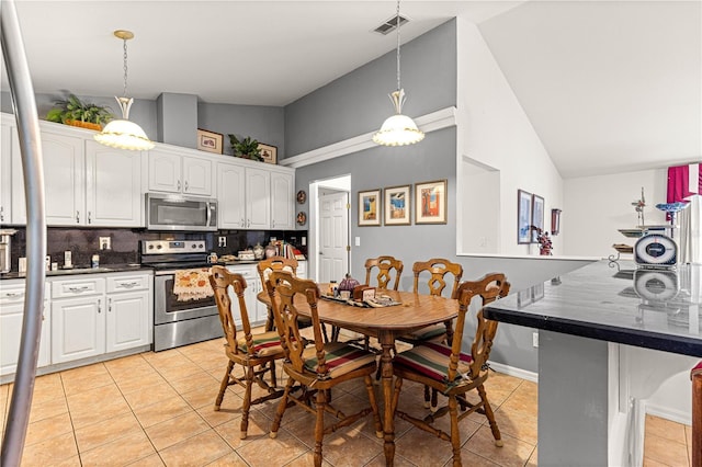 5445 NE Anthony Rd, Ocala, FL 34475 - dining space with light tile patterned floors and lofted ceiling