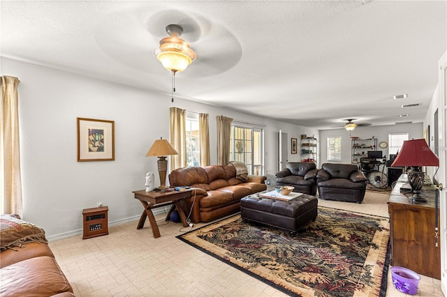 5445 NE Anthony Rd, Ocala, FL 34475 - living area featuring ceiling fan, baseboards, and a textured ceiling