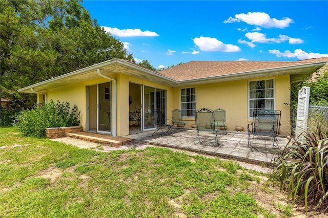 5445 NE Anthony Rd, Ocala, FL 34475 - back of house featuring stucco siding, a patio, and roof with shingles