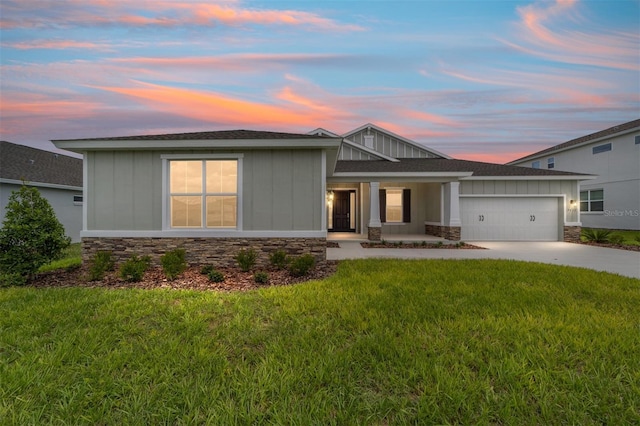 7513 SW 56th Pl, Ocala, FL 34474 - view of front of house with stone siding, a garage, driveway, board and batten siding, and a lawn