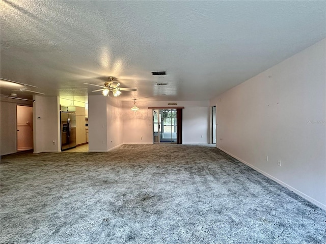 2020 W Snowy Egret Pl, Citrus Springs, FL 34434 - unfurnished living room featuring a ceiling fan, light colored carpet, baseboards, and a textured ceiling