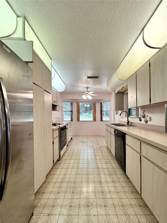 2020 W Snowy Egret Pl, Citrus Springs, FL 34434 - kitchen featuring black appliances, a textured ceiling, light countertops, a sink, and light floors