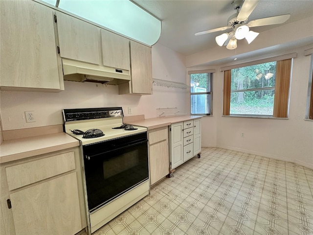 2020 W Snowy Egret Pl, Citrus Springs, FL 34434 - kitchen with electric stove, under cabinet range hood, light countertops, ceiling fan, and light flooring