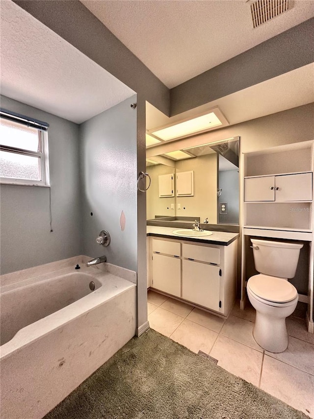 2020 W Snowy Egret Pl, Citrus Springs, FL 34434 - full bath featuring a garden tub, toilet, vanity, a textured ceiling, and tile patterned floors