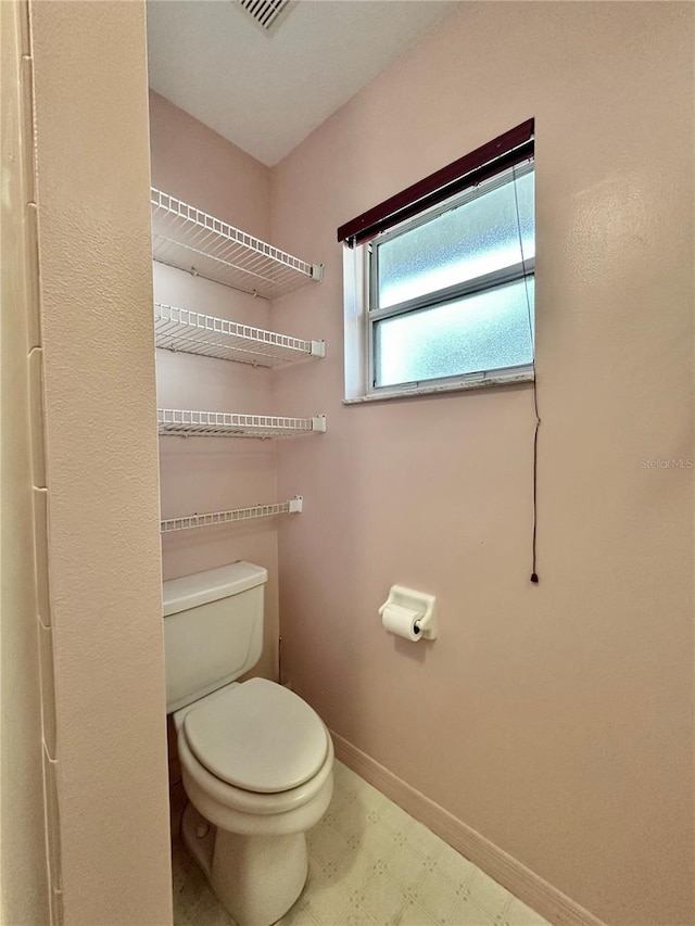 2020 W Snowy Egret Pl, Citrus Springs, FL 34434 - bathroom featuring tile patterned floors, toilet, and baseboards