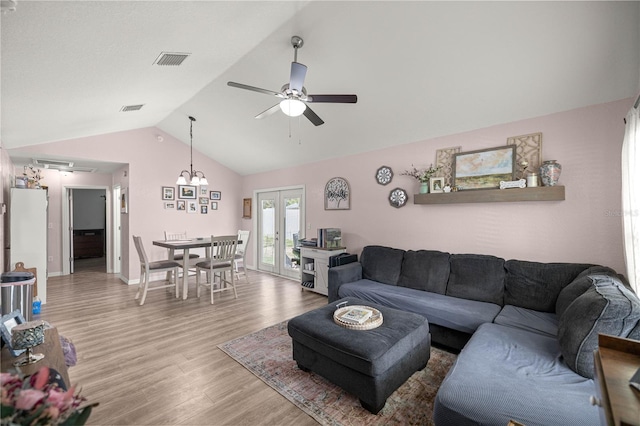 5063 SE 168th Ter, Ocklawaha, FL 32179 - living room with vaulted ceiling, light wood-style floors, a ceiling fan, baseboards, and french doors