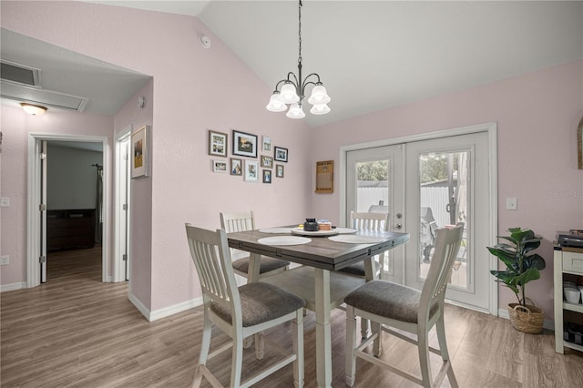 5063 SE 168th Ter, Ocklawaha, FL 32179 - dining area featuring vaulted ceiling, french doors, light wood finished floors, baseboards, and a chandelier