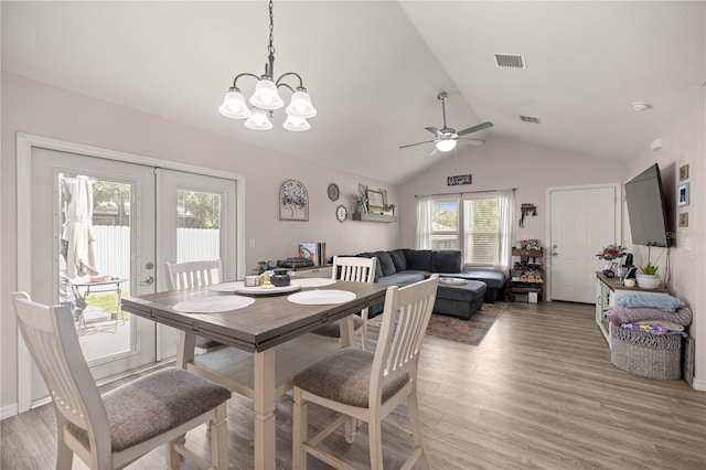 5063 SE 168th Ter, Ocklawaha, FL 32179 - dining area featuring vaulted ceiling, ceiling fan, light wood-type flooring, and a chandelier