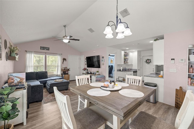 5063 SE 168th Ter, Ocklawaha, FL 32179 - dining space featuring light wood-style flooring, lofted ceiling, ceiling fan, and a chandelier