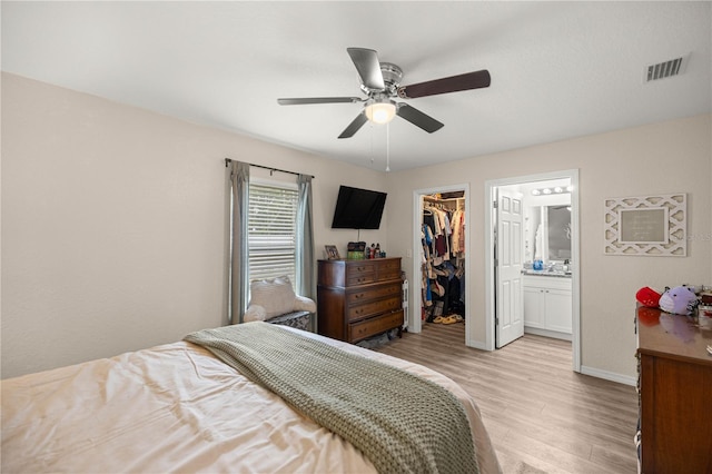 5063 SE 168th Ter, Ocklawaha, FL 32179 - bedroom with a spacious closet, light wood-style floors, a closet, baseboards, and ceiling fan