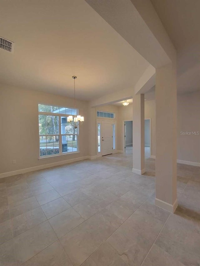 13977 SW 81st St, Dunnellon, FL 34432 - unfurnished room featuring a chandelier, light tile patterned floors, and baseboards