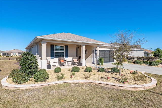 8878 SW 103rd Cir, Ocala, FL 34481 - view of front of home with a porch, concrete driveway, stucco siding, and a garage