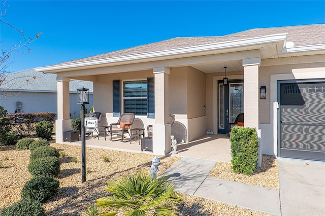 8878 SW 103rd Cir, Ocala, FL 34481 - doorway to property featuring covered porch, stucco siding, and roof with shingles