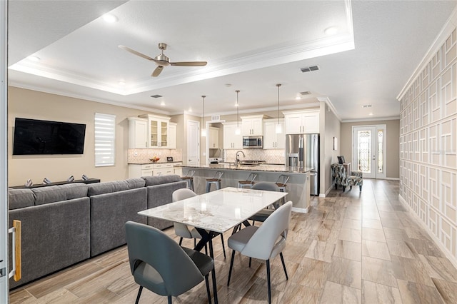 8878 SW 103rd Cir, Ocala, FL 34481 - dining space with a tray ceiling, ornamental molding, a ceiling fan, and recessed lighting