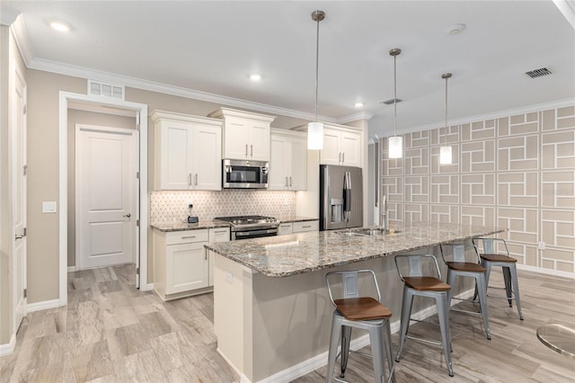 8878 SW 103rd Cir, Ocala, FL 34481 - kitchen with appliances with stainless steel finishes, a sink, a breakfast bar area, white cabinets, and crown molding