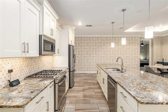 8878 SW 103rd Cir, Ocala, FL 34481 - kitchen with stainless steel appliances, a sink, crown molding, tasteful backsplash, and a kitchen island with sink