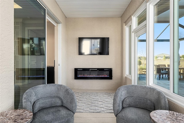 8878 SW 103rd Cir, Ocala, FL 34481 - sitting room with healthy amount of natural light, a textured wall, and a glass covered fireplace