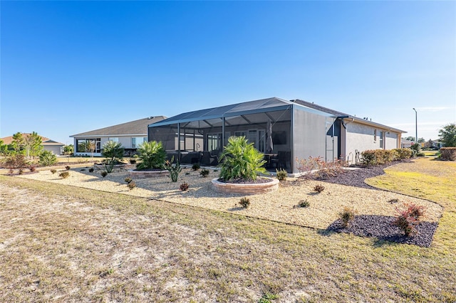 8878 SW 103rd Cir, Ocala, FL 34481 - back of house featuring glass enclosure and a lawn