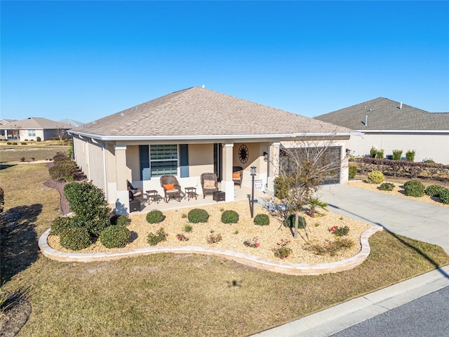 8878 SW 103rd Cir, Ocala, FL 34481 - view of front facade with a porch, concrete driveway, a garage, and stucco siding