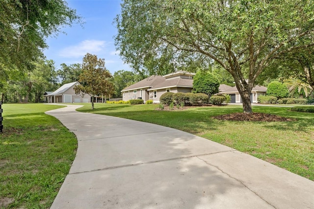 659 NW 155th Way, Newberry, FL 32669 - view of front of property featuring a front lawn, a detached garage, and stucco siding