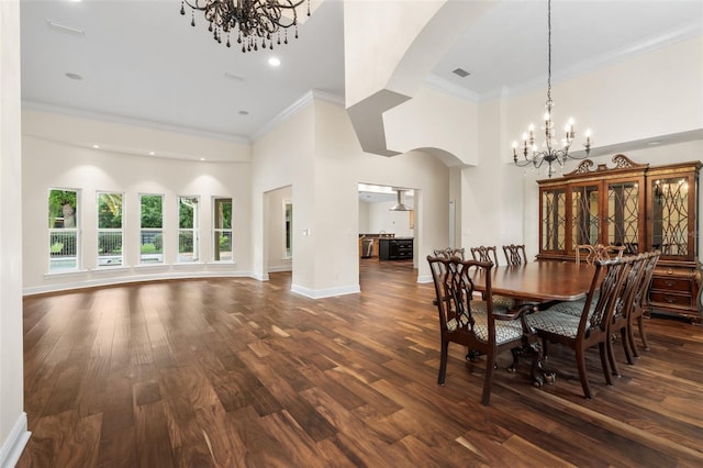 659 NW 155th Way, Newberry, FL 32669 - dining space with a chandelier, arched walkways, ornamental molding, a towering ceiling, and dark wood-type flooring