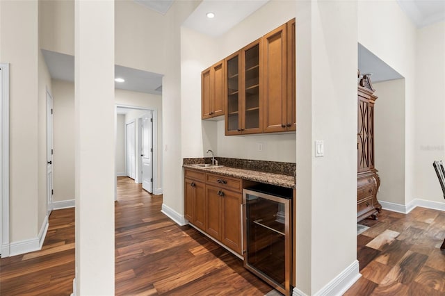 659 NW 155th Way, Newberry, FL 32669 - kitchen with wine cooler, brown cabinetry, dark wood finished floors, glass insert cabinets, and recessed lighting