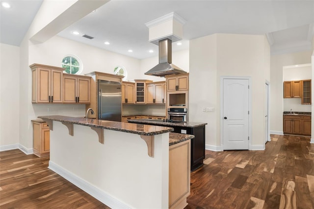 659 NW 155th Way, Newberry, FL 32669 - kitchen featuring stainless steel appliances, a center island with sink, a kitchen bar, dark wood-style flooring, and recessed lighting