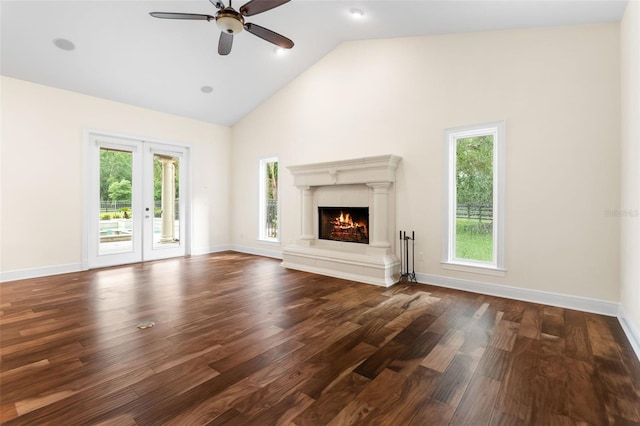 659 NW 155th Way, Newberry, FL 32669 - unfurnished living room featuring a ceiling fan, dark wood-style floors, high vaulted ceiling, and a lit fireplace
