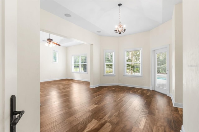 659 NW 155th Way, Newberry, FL 32669 - unfurnished living room with dark wood-style floors, a chandelier, and a ceiling fan