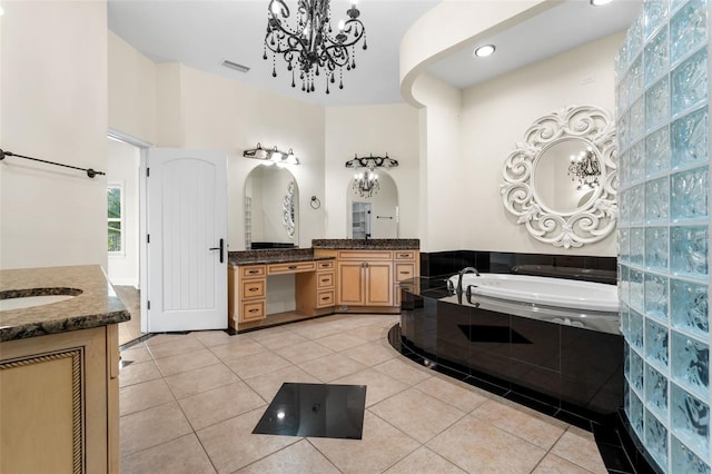 659 NW 155th Way, Newberry, FL 32669 - bathroom featuring a chandelier, two vanities, tile patterned floors, a bath, and recessed lighting