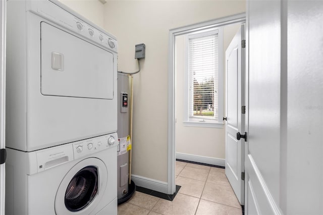 659 NW 155th Way, Newberry, FL 32669 - washroom featuring stacked washer and clothes dryer, light tile patterned floors, and water heater