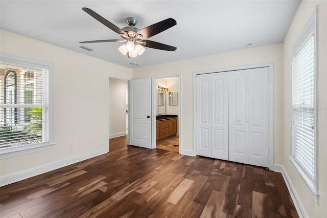 659 NW 155th Way, Newberry, FL 32669 - unfurnished bedroom with dark wood-type flooring, a closet, ensuite bath, and ceiling fan