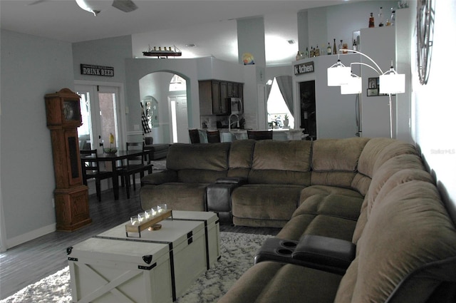 14126 Greater Pines Blvd, Clermont, FL 34711 - living area with ceiling fan, arched walkways, and light wood-style floors