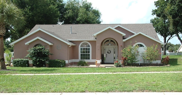 14126 Greater Pines Blvd, Clermont, FL 34711 - single story home featuring stucco siding, a front yard, and a shingled roof