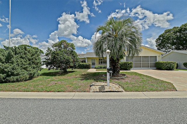 10699 SE 178th St, Summerfield, FL 34491 - obstructed view of property featuring concrete driveway, a garage, and a front lawn