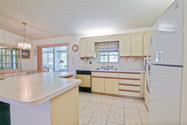 10699 SE 178th St, Summerfield, FL 34491 - kitchen with freestanding refrigerator, dishwashing machine, a textured ceiling, a chandelier, and light countertops