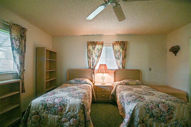 10699 SE 178th St, Summerfield, FL 34491 - bedroom featuring multiple windows, a textured ceiling, a ceiling fan, and dark carpet