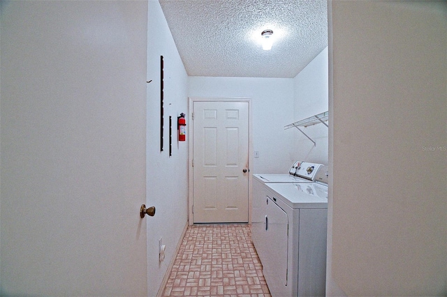 10699 SE 178th St, Summerfield, FL 34491 - laundry area featuring washer and dryer, a textured ceiling, and brick patterned flooring