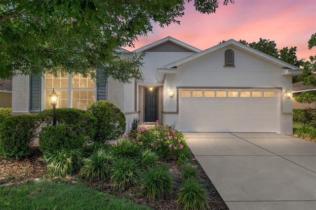 9805 SW 95th Loop, Ocala, FL 34481 - ranch-style house featuring stucco siding, an attached garage, and driveway