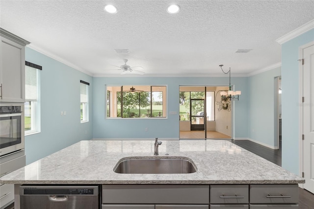 9805 SW 95th Loop, Ocala, FL 34481 - kitchen with appliances with stainless steel finishes, a sink, gray cabinets, a textured ceiling, and ornamental molding