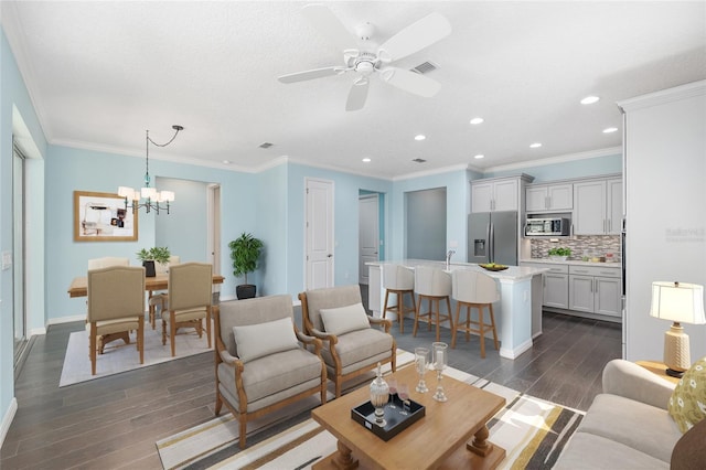 9805 SW 95th Loop, Ocala, FL 34481 - living area featuring dark wood-style flooring, recessed lighting, a chandelier, baseboards, and a ceiling fan