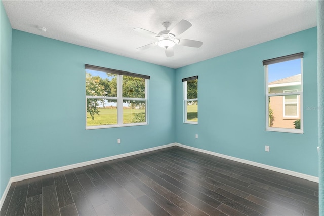 9805 SW 95th Loop, Ocala, FL 34481 - empty room featuring plenty of natural light, dark wood finished floors, a ceiling fan, baseboards, and a textured ceiling