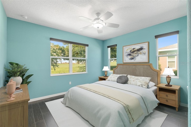 9805 SW 95th Loop, Ocala, FL 34481 - bedroom featuring multiple windows, baseboards, a textured ceiling, and ceiling fan