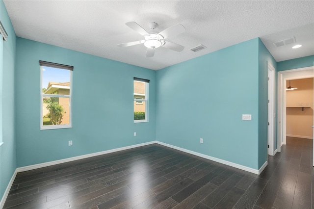 9805 SW 95th Loop, Ocala, FL 34481 - empty room featuring baseboards, ceiling fan, dark wood-style flooring, and a textured ceiling