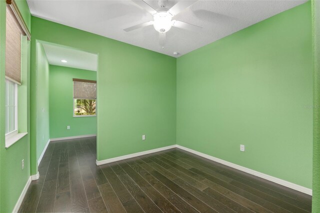 9805 SW 95th Loop, Ocala, FL 34481 - empty room with dark wood-style floors, a ceiling fan, and baseboards