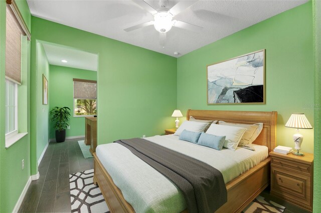 9805 SW 95th Loop, Ocala, FL 34481 - bedroom featuring baseboards, wood finished floors, and ceiling fan