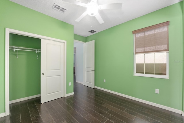 9805 SW 95th Loop, Ocala, FL 34481 - unfurnished bedroom with baseboards, a closet, dark wood-style flooring, and a ceiling fan