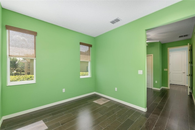 9805 SW 95th Loop, Ocala, FL 34481 - empty room with plenty of natural light, baseboards, and dark wood-style flooring