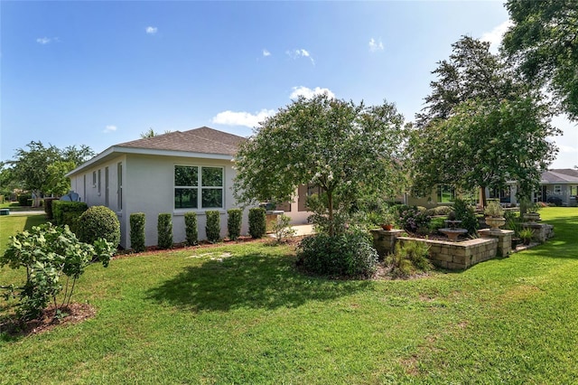 9805 SW 95th Loop, Ocala, FL 34481 - view of side of home with stucco siding, a yard, and roof with shingles