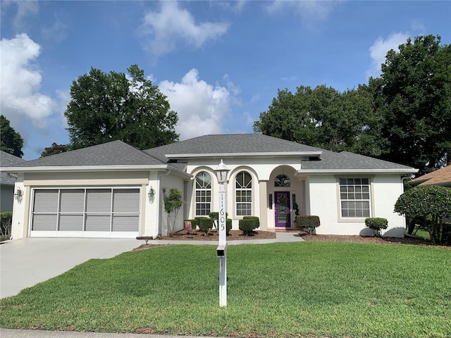 11605 SW 69th Cir, Ocala, FL 34476 - ranch-style home featuring an attached garage, a front yard, driveway, stucco siding, and roof with shingles